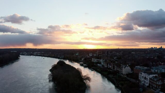 Rising drone shot of Chiswick Eyot island at sunset