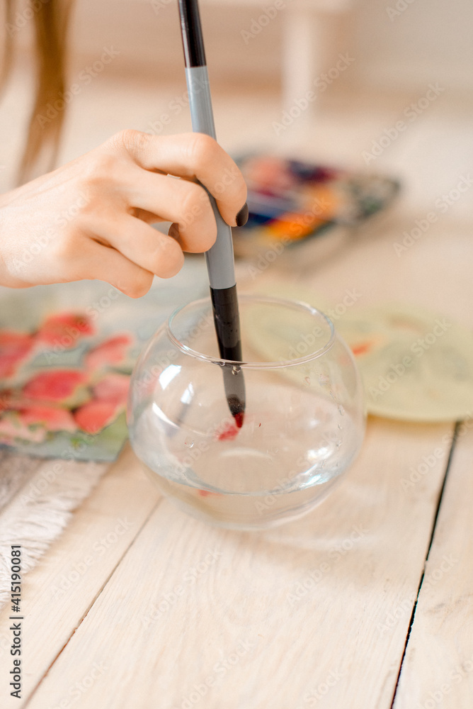 Wall mural portrait of a young woman painting at home