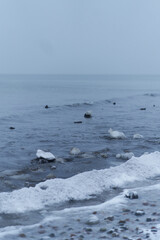 Snowy coast of the baltic sea. The sea is frozen in winter