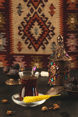 Ramadan concept with cup of tea and dried dates