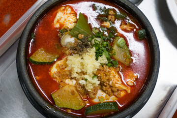 Korean spicy soft tofu stew pan isolated.