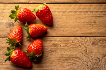 Various strawberries on rustic wooden boards with copy space
