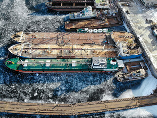Volga river. Wintering ships on a frozen river. There are many ships at the pier. Volgograd. Russia