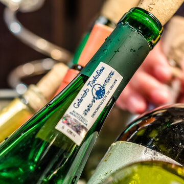 MADRID, SPAIN - AUGUST 27, 2017: Ice bucket with bottles of wine, highlighting a bottle of txakoli, a Spanish white wine from the Basque country region, with "Getariako Txakolina" DO certification