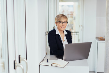 Smart businesswoman working at a small desk
