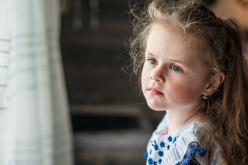 Cute little girl with long curly hair. Portrait