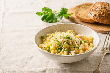Ditalini pasta with vegetables on linen tablecloth. Rural tasty healthy dinner. Close up. Domestic life.