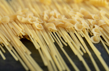 Various raw pasta on a dark background