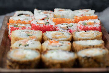 Sushi set on a wooden board with mixed ingredients