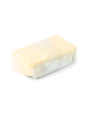 piece of butter made from cow's milk wrapped in transparent paper  side view on white background isolated with clipping path closeup. Selective focus.