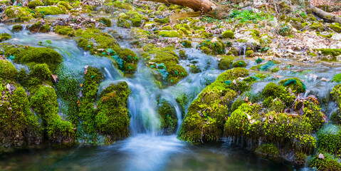 closeup small waterfall on the mountain river, outdoor mountain canyon scene