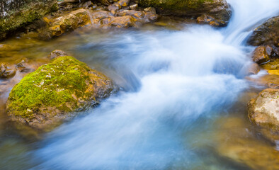 Fototapeta na wymiar small river rushing through the mountain canyon, spring outdoor scene