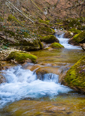 small river rushing through the mountain canyon, spring outdoor scene