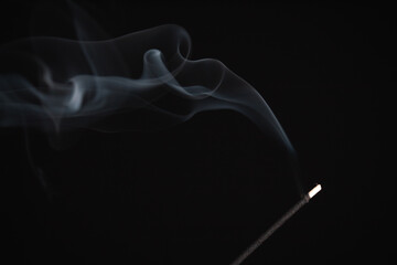 Incense burning giving of different patterns of smoke