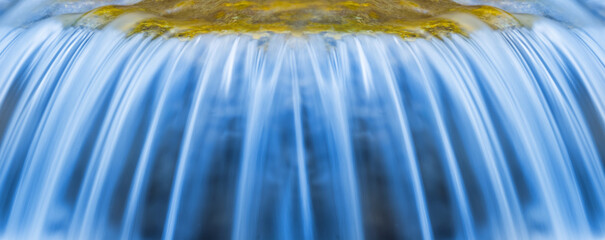 closeup waterfall on a mountain river, beautiful spring rushing water background