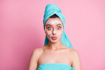 Photo of happy surprised young woman wear blue turban face mask lips pouted isolated pastel pink...