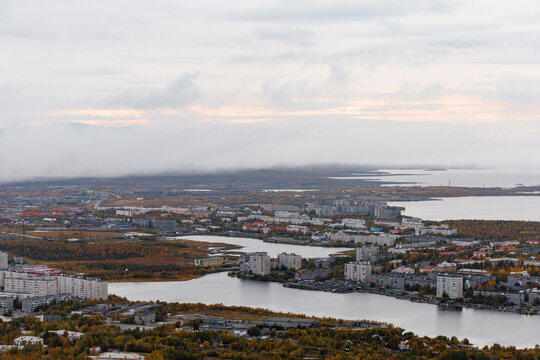 Autumn Panoramic view of the northern city of Monchegorsk, located among the mountains, taiga forest and many lakes. Orthodox Cathedral in the foreground. Kola Peninsula, Russia