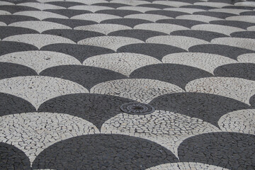 Mosaic of black and white paving stones