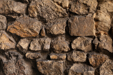 Close up of a brown stone wall.