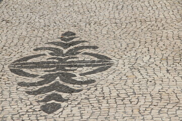 Mosaic ornament of black and white paving stones