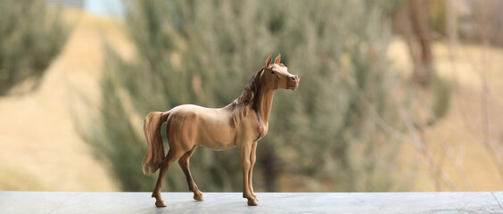 wooden figurine horse on nature background