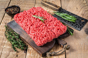 Fresh Raw mince beef  meat on a butcher cutting board with cleaver. Wooden background. Top view