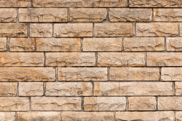 Beige stone wall close up.