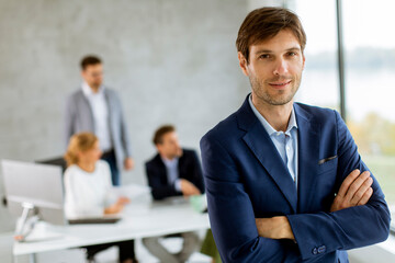 Handsome young business man standing confident in the office