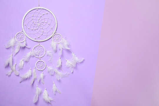 Beautiful dream catcher on color background, top view. Space for text