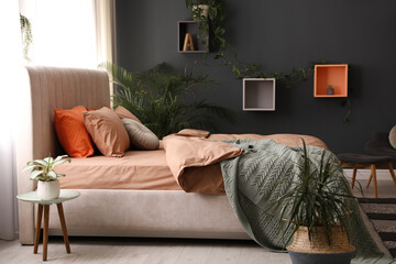 Bed with stylish cotton linens in room