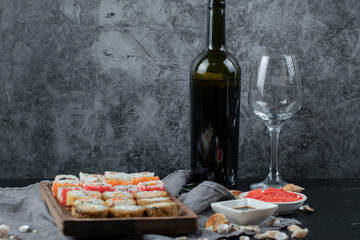 Sushi set with a bottle and glass of white wine