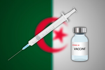 Syringe and vaccine vial on blur background with Algeria flag