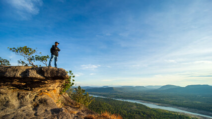 The atmosphere of the sky and clouds above the mountains of the Mekong River at Chana Dai cliff and has tourists, Ubon Ratchathani Province, Thailand.