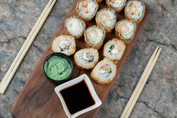 Hot fried sushi rolls with soy sauce and wasabi