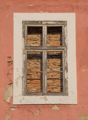 Old walled window with wooden frame close up