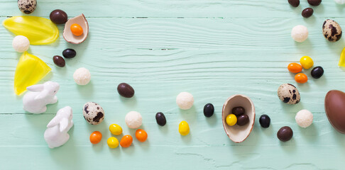 Easter background with chocolate eggs and candies