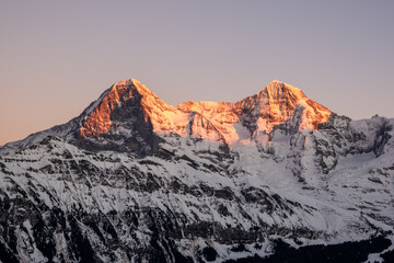 alpenglow last light on eiger and mönch mountains in the bernese alps switzerland - obrazy, fototapety, plakaty