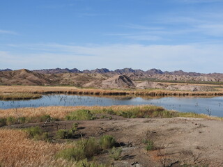 The beautiful lower Colorado River flowing through the desert, with jagged peaks in the background, Picacho State Recreation Area, Imperial County, California.	