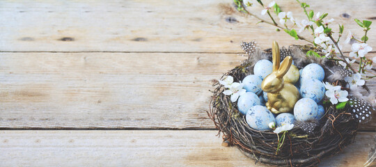 Happy Easter - greeting card - easter background - eggs in a basket on a wooden table