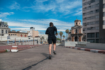 Young Man Running in the Street