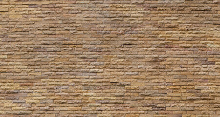 Yellow stone brick wall background.