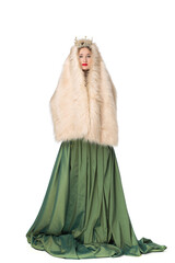 Fototapeta premium Fashion photo of a beautiful elegant young teenager girl with long curly hair in a crown. pretty long green skirt and fur cape isolated on white background. Russian beauty