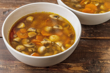 homemade champignon soup in a ceramic bowls on a wooden table