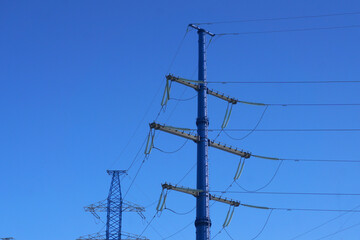  Power line pylons against the blue sky.