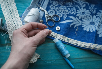 woman holding needle for basting fabric