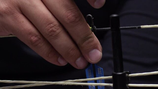 Close up of arrow being set in place on bow string