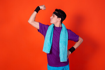 Funny young man and retro style. Sports and recreation. Bright colors. Orange background.