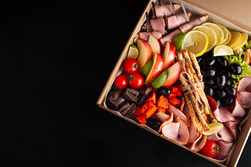 Gastronomic boxing, home delivery. Catering. Empty space for text, a gift for February 23, a birthday for a man.