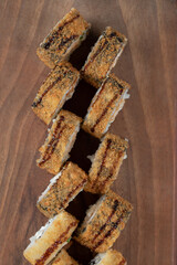 Fried hot rolls on a wooden board with crispy cover