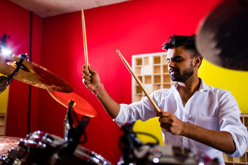 Fototapeta na wymiar italian artist musician playing drumms during online concert at studio.
